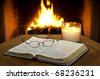 stock photo : An open Bible on a table in with a fireplace in the background.